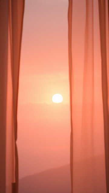 Soft Sunset Glow Through Sheer Curtains