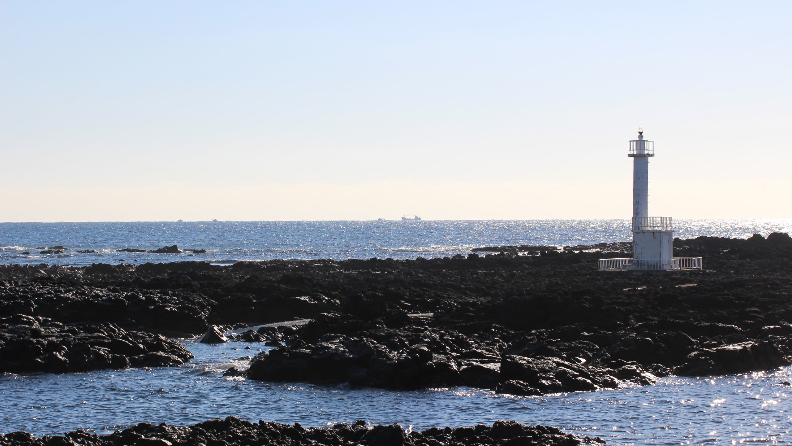 White Lighthouse on Volcanic Coast, lighthouse, coast, ocean, sea, volcanic rock, nature