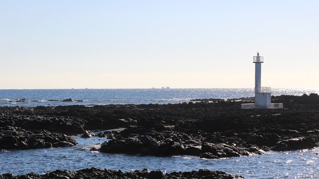 White Lighthouse on Volcanic Coast