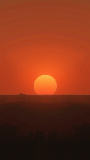 Minimalist Orange Sunset over Silhouetted Hills